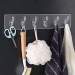 شريط تعليق جداري شفاف مزود بخافات أو خطافات متعددة (Clear Adhesive Wall Hook Strip / Multi-Hook Organizer).